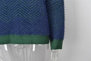 Detailed close-up of a women's knit sweater featuring a blue and green chevron pattern