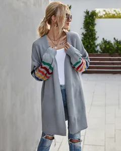 Long gilet gris avec des manches à rayures arc-en-ciel vives porté par un mannequin