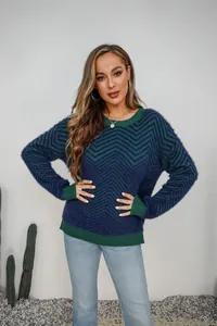 Close-up of crewneck fuzzy knit sweater with navy and green chevron pattern