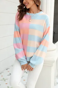 Detail of a colorful striped knit sweater with pastel color block design and crew neck.