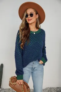 Detail view of a women's crew neck fuzzy sweater with blue and green chevron knit pattern