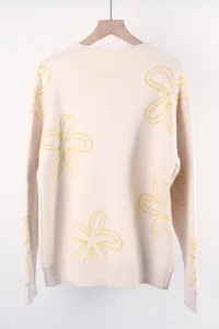 Detailed back view of a cream plus size knit sweater featuring yellow floral line patterns