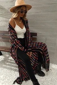 Detailed shot of the vibrant knit texture and long fringe hem on this stylish cardigan.