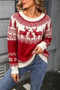 Detailed view of red Christmas sweater with festive reindeer and tree jacquard patterns