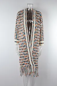 Detailed view of a long fringed knit cardigan sweater with colorful geometric patterns