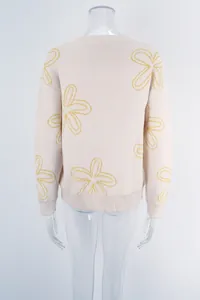 Back view of a beige crew neck knit sweater with large yellow flower patterns on mannequin