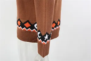 Macro view of brown Halloween knit sweater sleeve and hem with geometric patterns