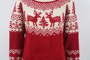Close-up of vintage Christmas sweater with red reindeer and tree jacquard patterns.