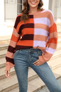 Detailed view of color-blocked striped knit sweater with vibrant orange and purple tones.