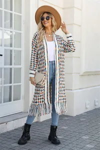 Bohemian long knit cardigan with colorful grid pattern and fringe hem detail view