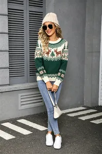 Model wearing a vintage green Christmas sweater with reindeer patterns in an outdoor setting