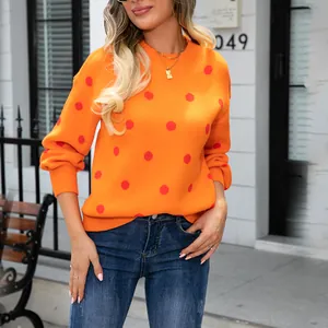 Stylish women's orange knit sweater with red polka dots, perfect for casual spring wear.