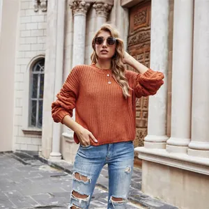 Stylish women's rust orange knitted pullover sweater with oversized sleeves and cropped fit