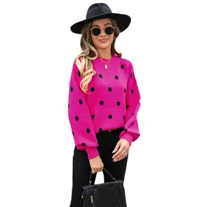 Vibrant hot pink knit sweater featuring bold black polka dots for women's spring fashion
