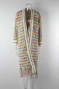 Detailed view of a colorful rainbow plaid long knit cardigan with fringe hem on mannequin