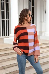 Detailed view of a vibrant color-block striped crewneck knit sweater for women.