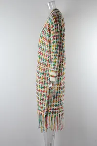 Side detail of a colorful textured knit long cardigan with tassel fringe at the hem
