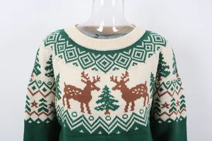 Detail of festive Christmas knit sweater with reindeer and tree jacquard patterns