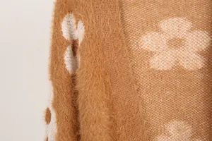 Primer plano de la textura de punto esponjosa y el patrón de flores en cárdigan camel