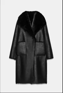 Full-length view of a black reversible shearling coat with a luxurious faux fur collar.