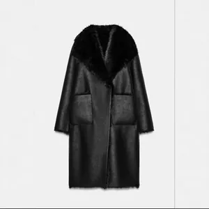 Elegant women's long reversible black faux shearling coat with plush fur collar