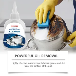 Jakehoe pot bottom cleaner removing stubborn burnt grease from a stainless steel pan.