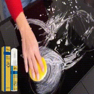 Detail of multi-purpose foam cleaner removing stains on stovetop with sponge