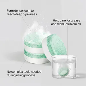 Effervescent drain cleaning tablet dissolving in water to form dense pipe cleaning foam.
