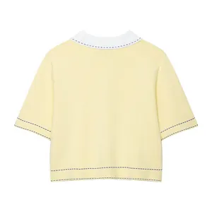Detailed back view of a pale yellow knit polo shirt with stylish contrast purple stitching