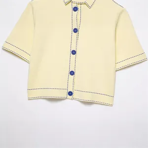 Chemise jaune à manches courtes en tricot avec coutures contrastées bleues et boutons