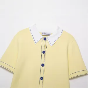 Casual yellow knit polo shirt for women featuring a white collar and blue contrast stitching