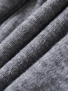 Close-up macro view of high-quality grey knitted fabric showing soft wool texture details