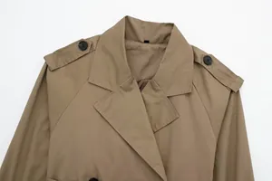 Detailed macro shot of a classic khaki trench coat featuring lapel collar and epaulettes