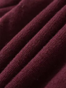 Close-up macro view of premium burgundy knitted fabric showing soft texture detail