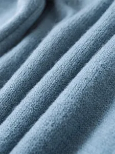 Macro view of soft blue knitted fabric texture on loose pullover sweater