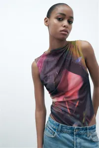 Sleeveless pleated mesh bodysuit featuring a colorful abstract print and a sexy slim fit style