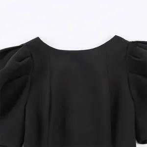 Detailansicht eines eleganten schwarzen Oberteils mit Puffärmeln