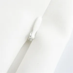 Macro view showing the seamless hidden zipper detail of a white fashion halter neck top