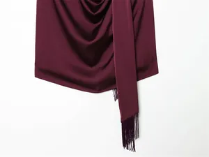 Nahaufnahme eines burgunderroten Satin-Halterneck-Tops mit eleganten Fransen-Details