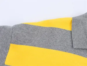 Macro view of a yellow and grey striped knit sweater highlighting collar stitching