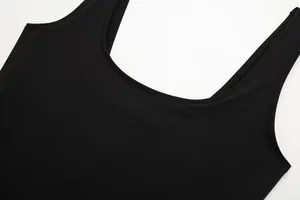 Close-up detail of the U-neckline and stitching on a black slim-fit stretch bodysuit.