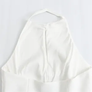 Close-up detail of a stylish white halter neck top with a keyhole back opening