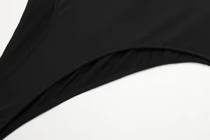 Close-up macro view of the stitching and fabric on a black elastic slim bodysuit