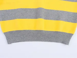 Close-up detail of a knitted sweater featuring yellow and grey horizontal stripes and hem.