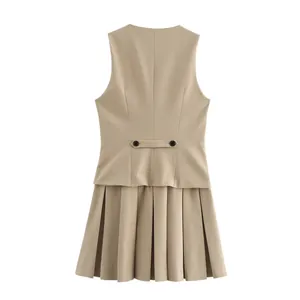 Back view of khaki sleeveless pleated dress showing decorative waist buttons