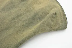 Vista dettagliata della trama del tessuto denim lavato giallo con cuciture resistenti.
