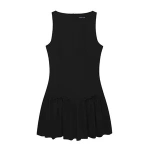 Sleeveless black mini dress with elegant boat neck and ruffled hem featuring bow details