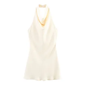 Close-up of the elegant cowl neck and smooth satin fabric of this cream halter mini dress