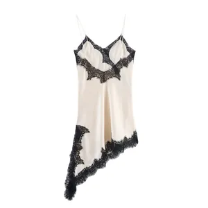 Elegant cream asymmetrical slip dress featuring intricate black lace trim detailing