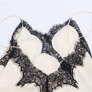 Close-up of delicate black eyelash lace trim on a sexy cream camisole dress bodice.